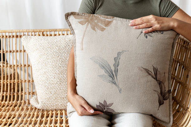 istock Floral beige cushion held by a woman interior design 2156879541