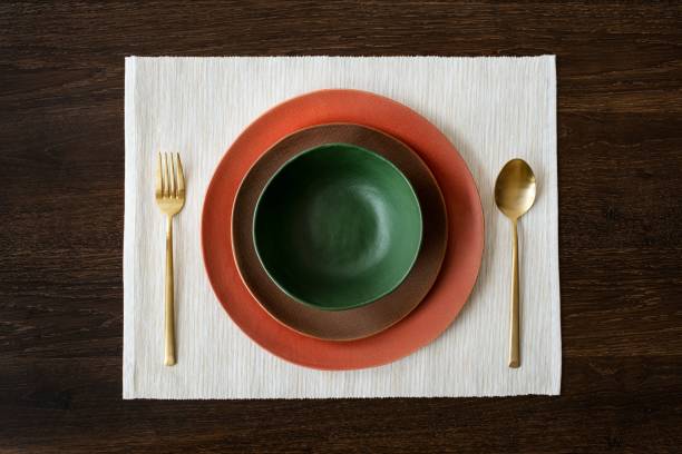 istock Colorful dinnerware set on a wooden table aerial view 2156879597