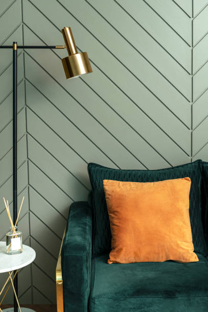 istock Orange  cushion on a sofa retro interior design 2156879619