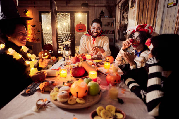 istock Happy black family having fun during Halloween at dining table. 2156879707