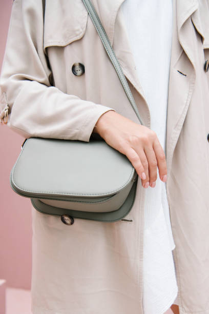 istock Woman in a beige coat with her shoulder bag 2156879792