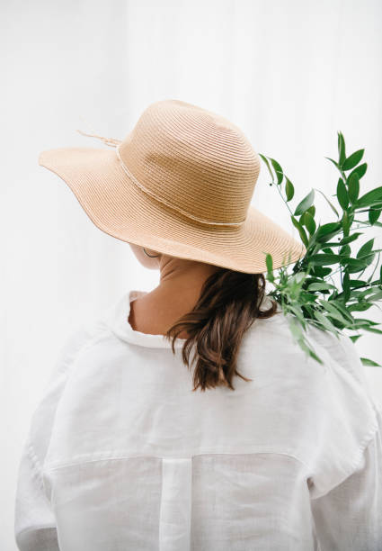 istock Woman wearing a woven hat carrying eucalyptus leaves 2156879845