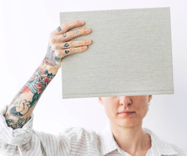 istock Tattooed woman holding a book mockup 2156880162