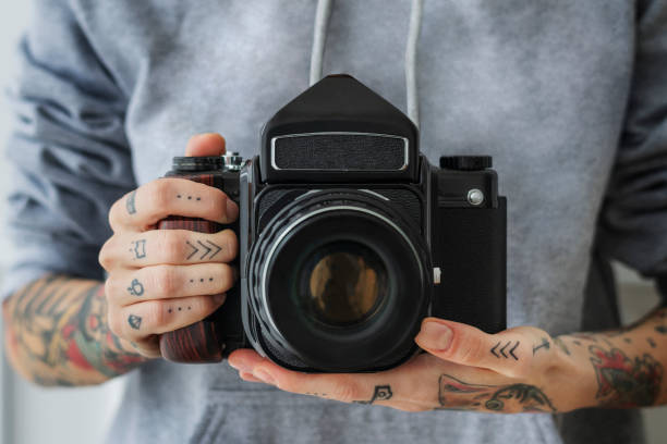 istock Photographer shooting with a black analog camera 2156880232