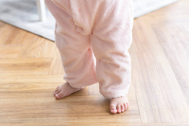 istock Baby's first steps with cute little feet 2156880267