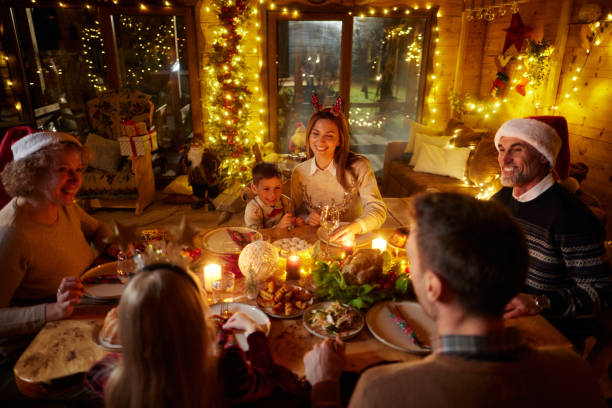 istock Happy extended family talking during New Year's dinner at dining table. 2156880347