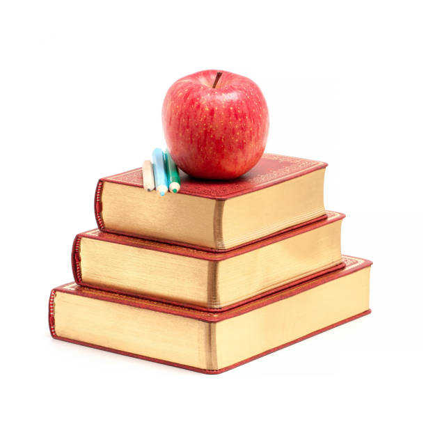 Books and Apple isolated on white background.