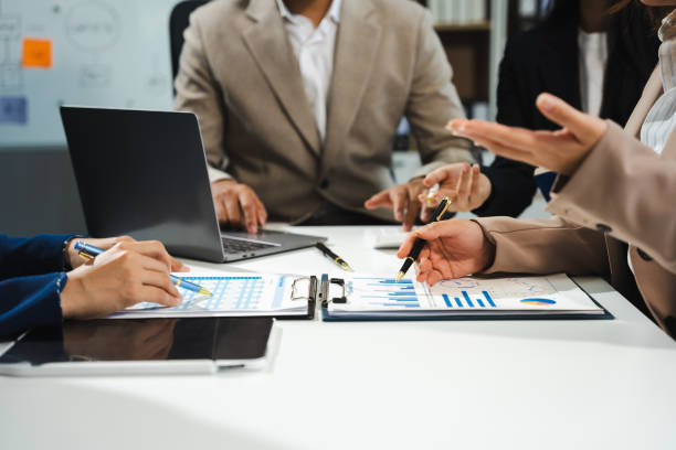 istock Business team calculate and analyzing graph document financial with laptop and digital tablet in office. 2156881193