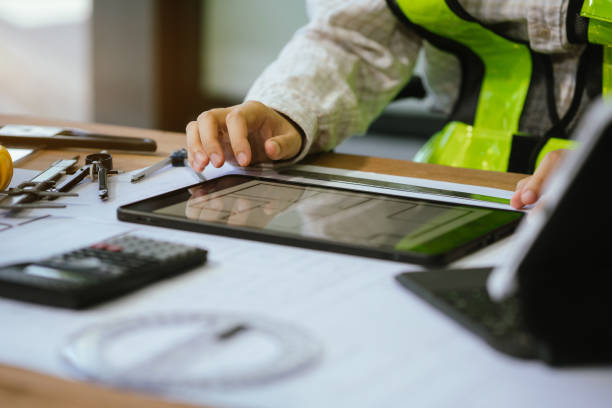 istock Person's engineer Hand Drawing Plan On Blue Print with architect equipment, Architects discussing at the table, team work and work flow construction concept. 2156881229