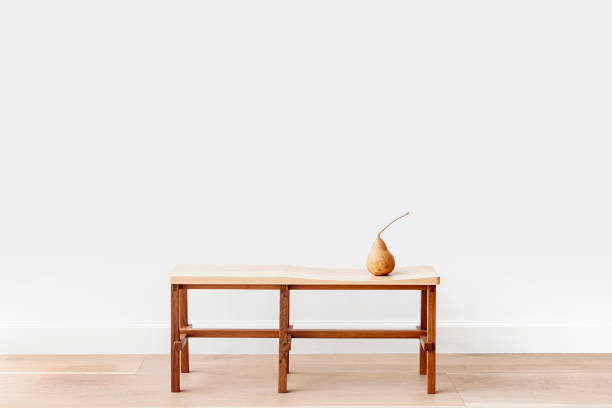 istock Brown pear on a wooden bench in a white room 2156881417