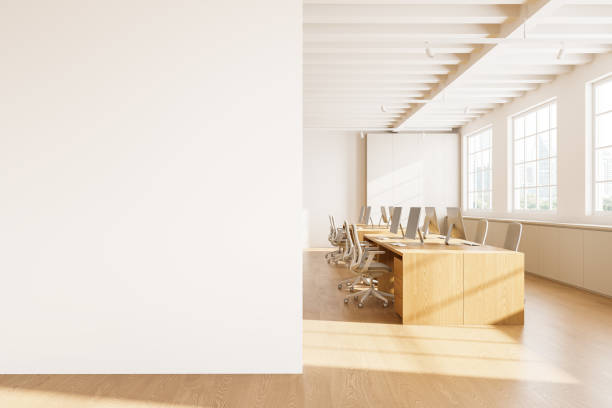 istock Cozy coworking interior with pc computers on shared desk, mock up wall 2156882289