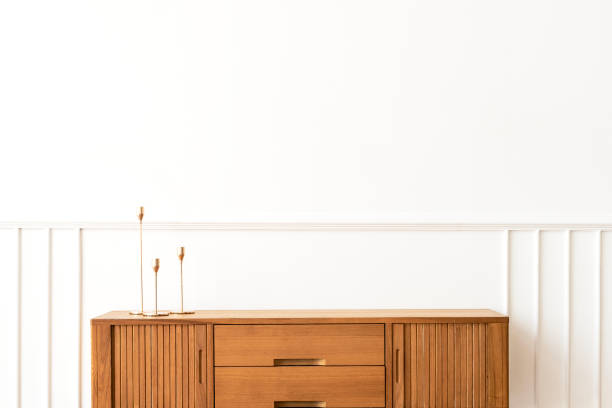 istock Taper candle holders on a wooden sideboard table 2156882405