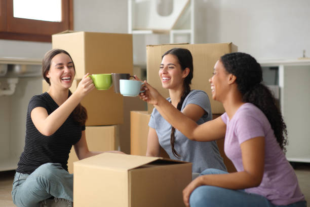 istock Three happy roommates toasting moving house 2156883796