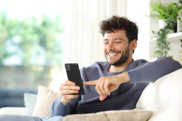 istock Happy man using smart phone in a house interior 2156884090