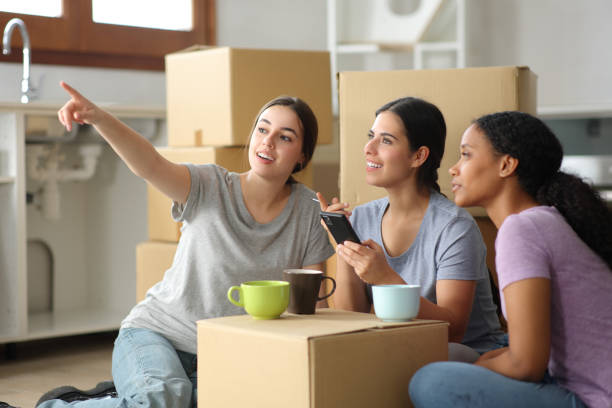 istock Three roommates planning decoration moving home 2156884158