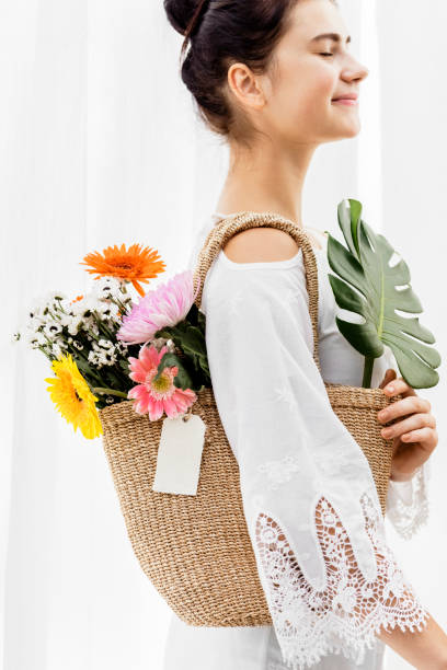 istock Girl carrying a bouquet in her bag 2156884242