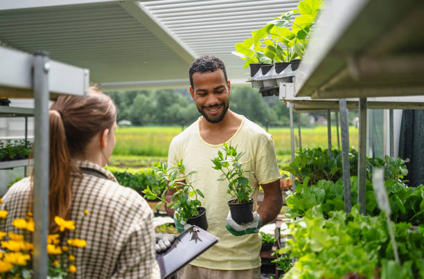 istock Gardening Professionals with Tablet and Seedlings 2156884997