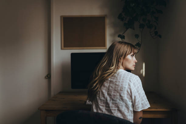 istock Woman sitting in front of a computer during coronavirus quarantine 2156885531