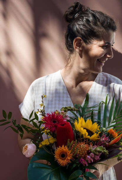 istock Woman with a beautiful tropical bouquet 2156886323