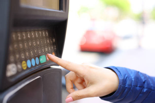 istock Woman hand using parking meter in the street 2156886459