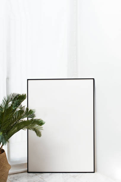 istock Blank black frame mockup by palm leaves 2156886591