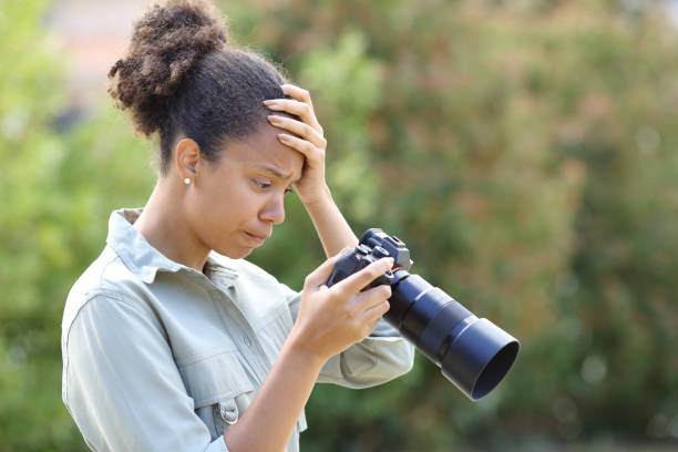 istock Frustrated black photographer checking result on camera 2156886747