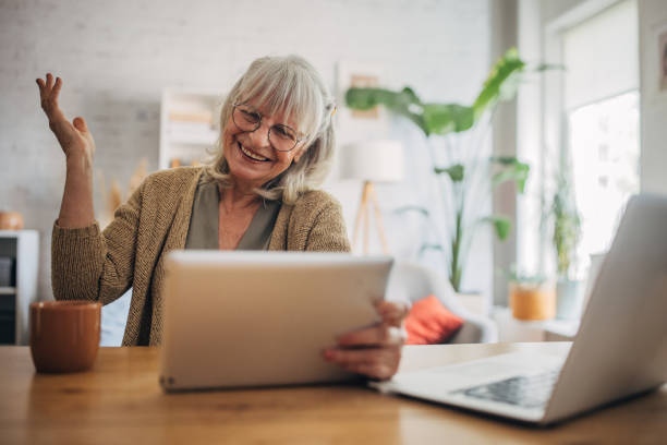 istock Elderly woman using a digital tablet and talking on video chat 2156887658