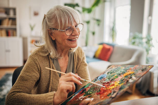 istock Elderly woman painting on canvas 2156887741