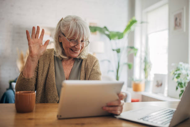 istock Elderly white woman using a digital tablet and talking on video chat 2156887799