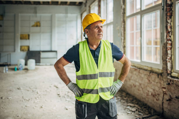 istock White male construction worker with a helmet on construction site 2156888035