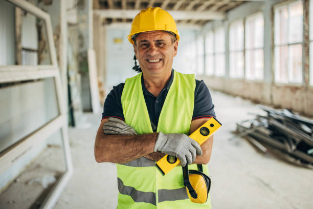 istock White male construction worker on construction site holding a spirit level 2156888043