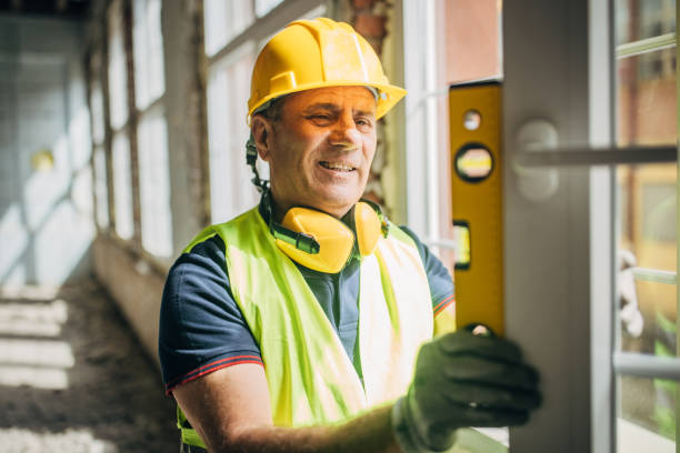 istock Male construction worker with a spirit level on construction site 2156888117