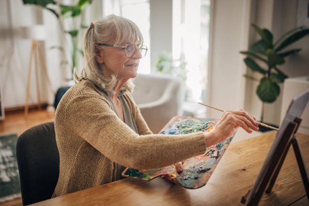 istock Senior woman painting on canvas 2156888225