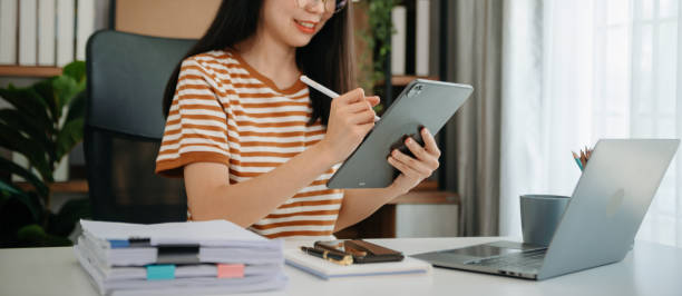 istock Businesswomen analyzing investment graph and discussing plan new start up project. Finance task. 2156888969