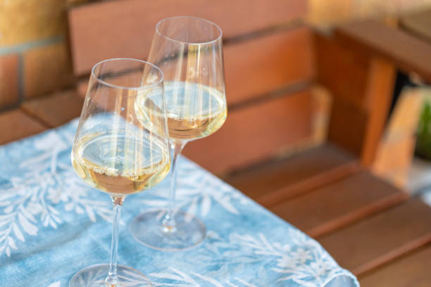 istock White wine glass with a chair on a patio 2156889296
