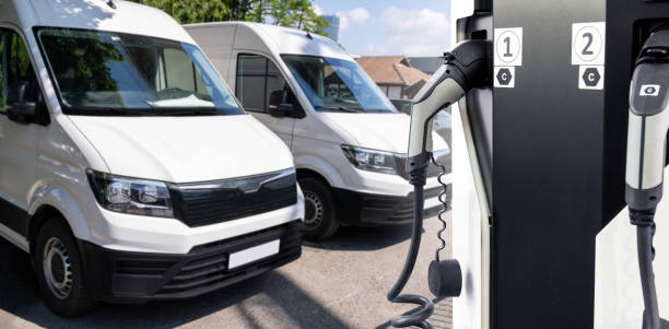 istock Electric delivery vans with electric vehicles charging station. 2156889408