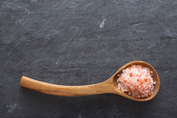 istock Himalayan pink salt in a wooden spoon 2156889973