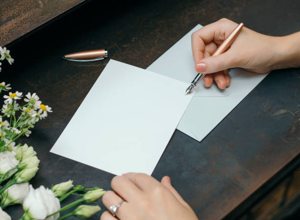 istock Woman writing on a blank card 2156890652