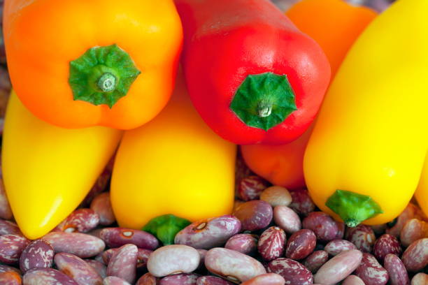 Various sizes and colors hot peppers on beans