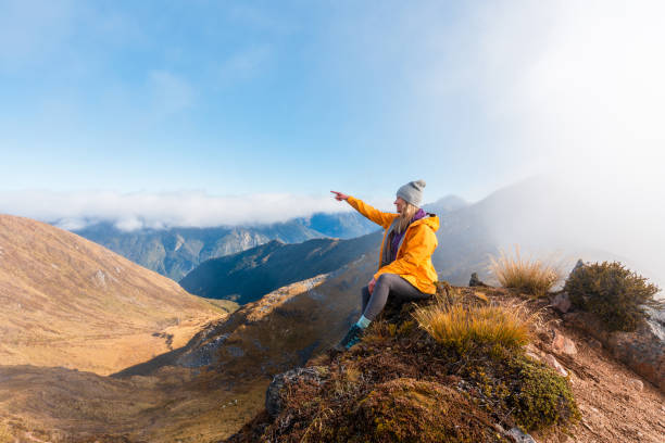 istock Woman hiker enjoying the view from mountain peak. 2156895160