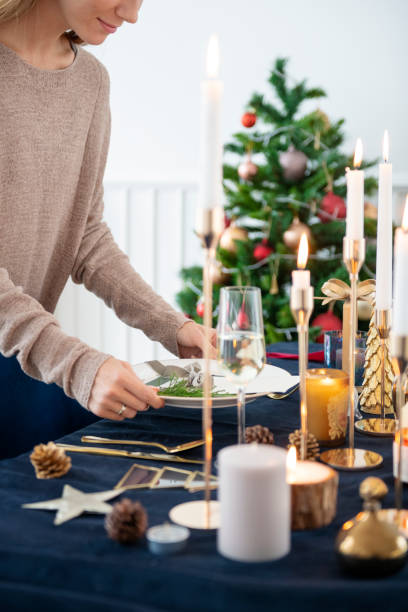 istock Blond woman setting up a Christmas dining table 2156896156