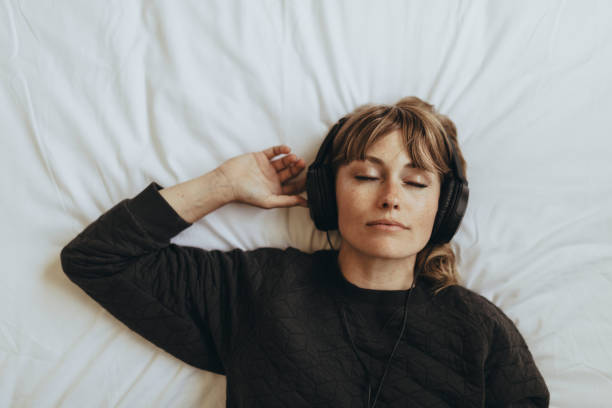 istock Woman listening to music  during coronavirus quarantine 2156896247