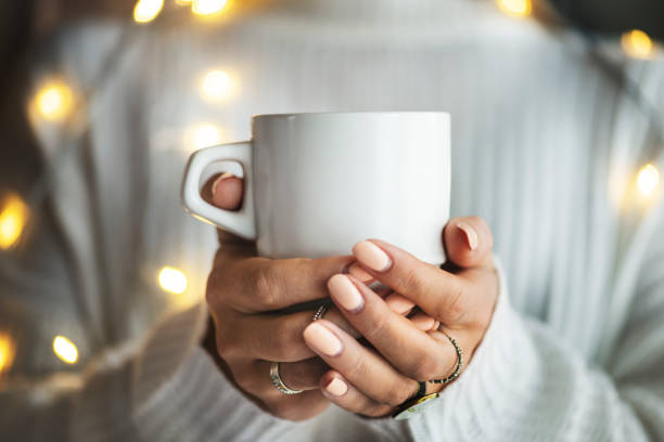 istock Woman in a white sweater with a white cup 2156896548