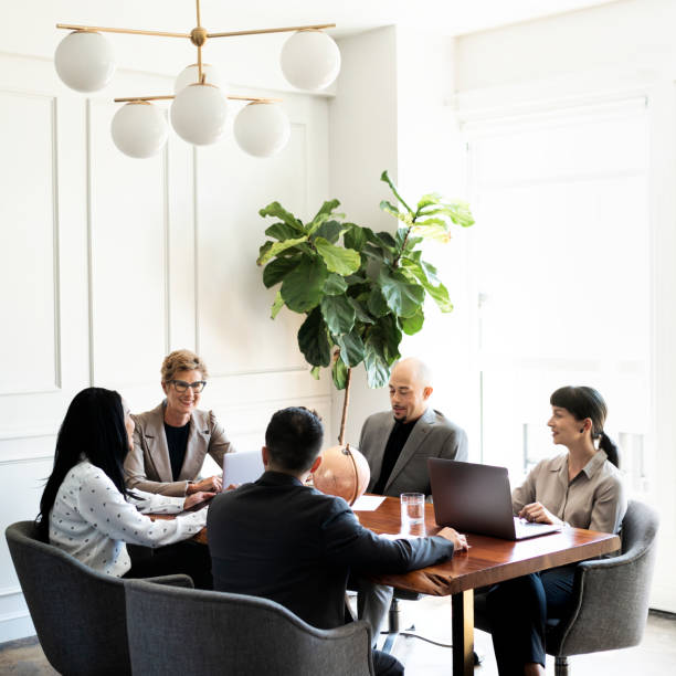 istock Happy business people in a meeting 2156896797