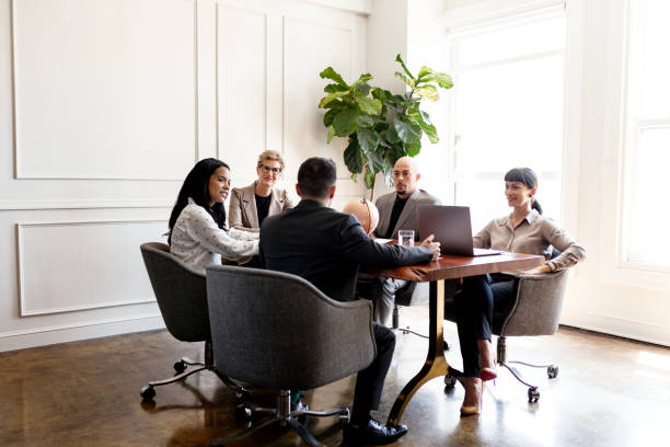 istock Happy business people in a meeting 2156896811