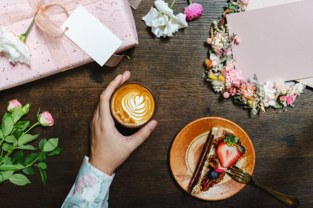 Woman enjoying coffee with a slice of strawberry cake