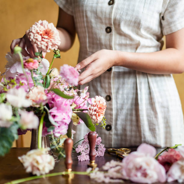istock Florist adding pip salmon to a vase 2156897388