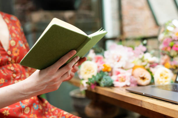 Florist reading a book at her shop