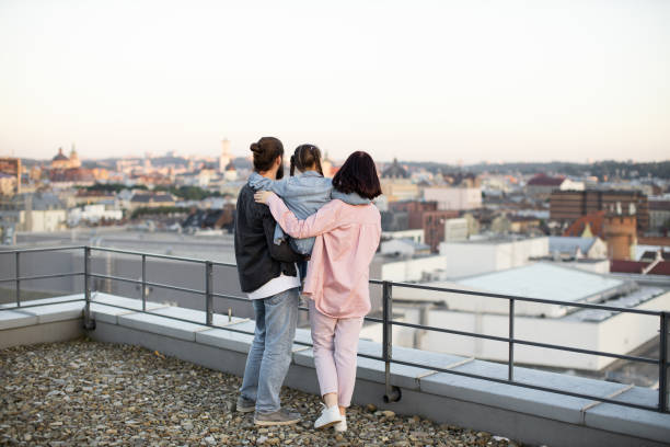 istock Family enjoying city view from rooftop at sunset 2156898114