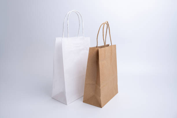 istock Kraft paper bag on a light background. Delivery and shopping concept. Packaging template mockup 2156898350
